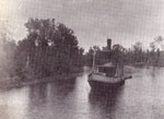 Tugboat on Forested River, circa 1915.