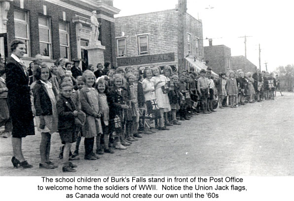 The school children of Burk's Falls stand in front of the Post Office to welcome home the soldiers of WWII. Courtesy the Burk's Falls, Armour & Ryerson Union Public Library.