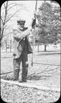 Photograph of a man, possibly James Bawden or George Usborne, pulling the rope of the town bell, Victoria Park, Colborne