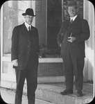 Photograph of Frank Griffis and an unidentified man standing in front of W. F. Griffis Drug Store, King Street East, Colborne