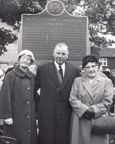 Mr. Farquhar Oliver, MPP South Grey, with Mrs. Gertha Reany (née MacPhail) and Mrs. Lillian Bailey (née MacPhail) in 1960 at the unveiling of the Agnes Macphail historical plaque in Hopeville, Ontario. Courtesy the Grey Roots Museum & Archives.