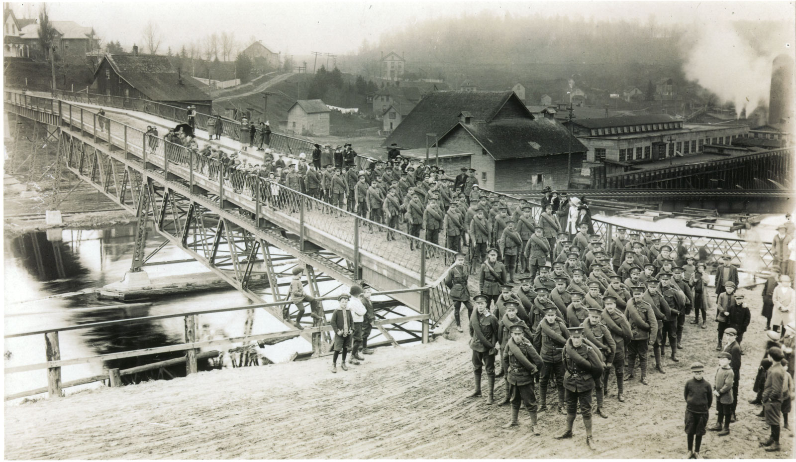 Women and children stand on the sidelines as a battalion marches through the town. <br>Courtesy the Sundridge - Strong Union Public Library.