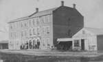 Elora Streetscape showing 3-storey building identified as Dalby House, also Gordon’s harness shop, and Mundell’s Cabinet Warehouse.
