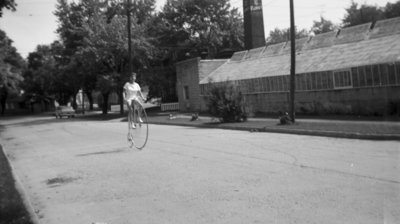 Linke's Greenhouse and Girl on Penny-farthing