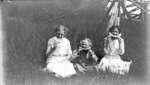 Middle Island:  Esther Hartlep (middle) with two unidentified girls eating watermelon in summer.