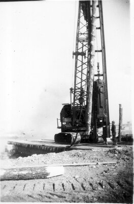 052 Crane placing log post in ground