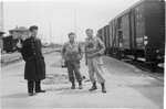 057 Three soldiers at train yard