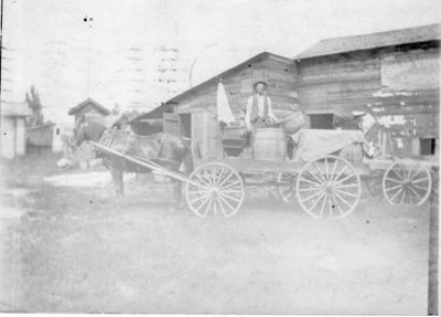 021 Charles Girard standing on horse drawn wagon