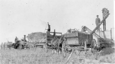 022 Farmers loading hay unto tractor wagons