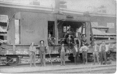 057 Crew of men posing around L.S. & M (Lake Superior & Mississippi) Railway car