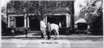 Bob Nesbitt, with his white horse, standing in front of his house in Brighton, Ontario, in 1932.