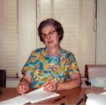 “Aunt Ruby” at the table with a writing pad in a flowered shirt. Stamped Mar 72.
