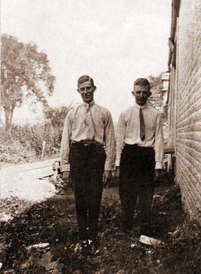 “Maurice Cheer (left) Ralph Cheer” standing outside at side of house.