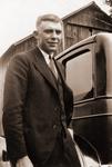 “Tommy” at car with roof of barn behind.