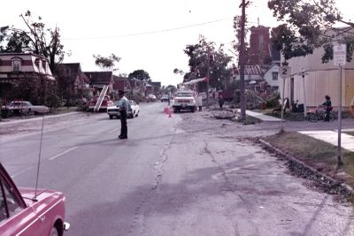 Police on duty as hydro lines repaired from tornado damage in Brighton, Ontario, Canada, 1973.