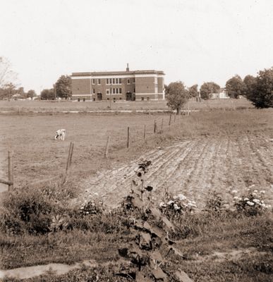 View of Brighton school through a farm field.  BHS from our front doorstep June 1944.