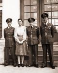 Three RCAF Officers and one woman.  The two Officers on the ends are pilots, the middle officer is part of the air crew.