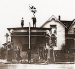 Gas Station with Local Residents Posing and waving a Union Jack