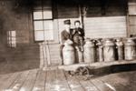 Conductor and small friend with the milk can wagon at the train station in Brighton, Ontario.