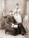Portrait of a young couple, the man is seated.