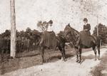 Two women riding horses side saddle (approximate date 1880-1920).