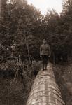 "Soldier standing on flume-running down from mill pond 200 yds approx from Motts mill on #2 Hwy Brighton" Another copy had the following details: "wooden flume running east and west back of Francis Stto, Motts Mill - Bill Goheen Reserve army 1923?".George Goheen, Ray Goheen, and JB Lenard.