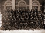 Soldiers Posing with Rifles in front of a Building