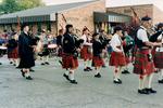 The Royal Canadian Legion Branch 100 Pipe Band marching along Dundas Street in Brighton, Ontario, Canada in the Applefest Parade in 1992.