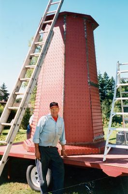 Harold Grills with the updated version of the Presqu'ile lighthouse Applefest float structure that he built.