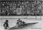 Three Kids Struggle in Water in Front of Crowd at Earl Haig