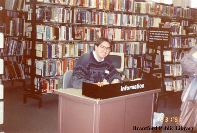 Employee at the Information Desk at the Carnegie Branch of the Brantford Public Library