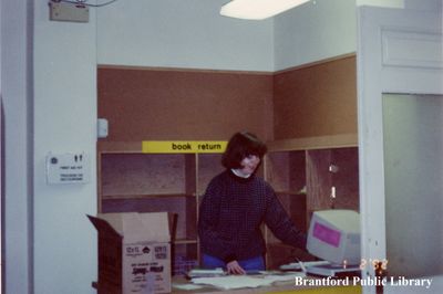 A Staff Member at the Book Return Desk at the Carnegie Building