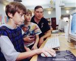 Two Boys and a Man Use a Computer at the Brantford Public Library