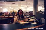 Staff Member Sits at the Desk at the Brantford Public Library