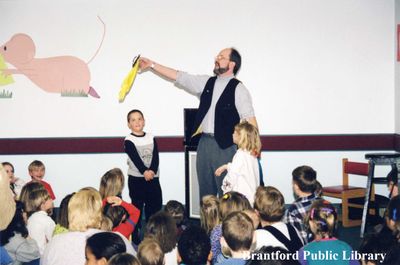 Magician Peter Mennie Performs for a Group of Children at the Brantford Public Library