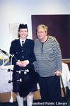 Board Member Jo Brennan with a Bagpiper at her Retirement Party at the Brantford Public Library