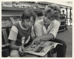 Library Staff Member Reads with Child at St. Paul Avenue Branch of the Brantford Public Library