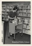 Staff Member Shelves Books at the St. Paul Avenue Branch of the Brantford Public Library, Summer 1975