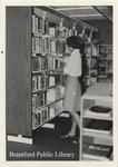 Unnamed Staff Member Shelves Books at the St. Paul Avenue Branch of the Brantford Public Library, Summer 1975