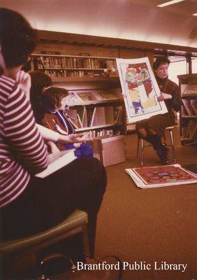 Staff Member at St. Paul Avenue Branch of the Brantford Public Library Showing Artwork, 1989