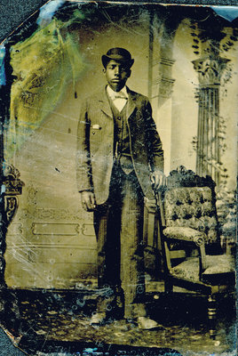 Tintype of Man with Derby Hat leaning against Chair [n.d.]