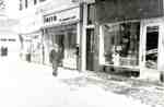 Hainsworth Drugs, Smith Hardware and Armstrong's Electrical Store, east side of Brant Street south of James Street,  snowy day ca 1942