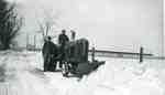 Gordon and Reg Sherwood with a Massey-Harris tractor and snowplow,  plowing out the lane, 1967