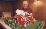 Gordon Sherwood with his models of the Sherwood farmhouse and the smaller barn, 2001