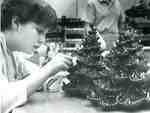 Tammy Dobson, Lord Elgin High School student, decorating chocolate Christmas trees, 1987