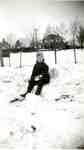 Russ Woodley in the snow chair outside the house on Balmoral Avenue, ca 1939
