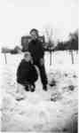 Betty and Russ  Woodley (sitting in the snow chair) playing in the snow, outside the house on Balmoral Avenue, ca 1939