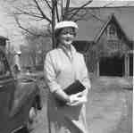 Juanita Simpkin standing in front of the original two-bay, two-storey carriage house, 923 Brant Street, 1957
