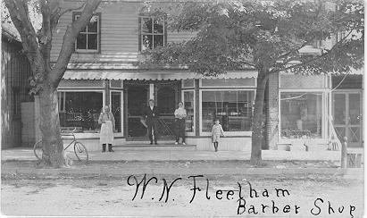 W.N. Fleetham Barber Shop -- Exterior with 4 people in front; dated 1907