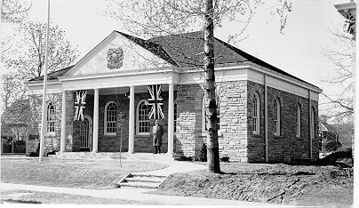 Old Post Office -- Exterior, with man and 2 flags in front